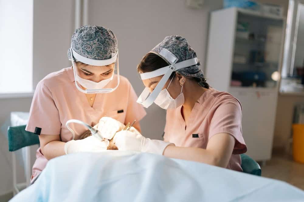 American Board physician undergoing case evaluation and examination for hair transplant in Bangkok practice