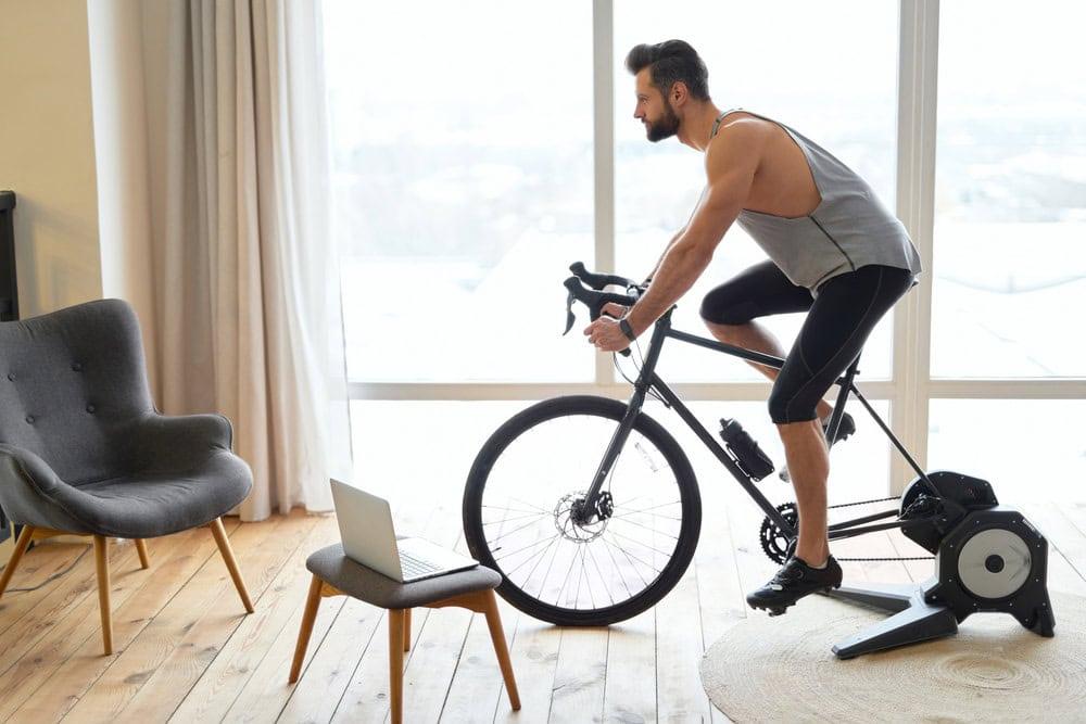 A man doing light stationary cycling as part of a gradual return to gym after hair transplantation